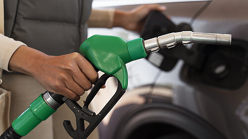 A person filling their car with petrol.