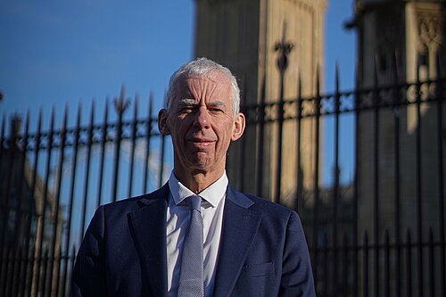 John in front of Parliament building 